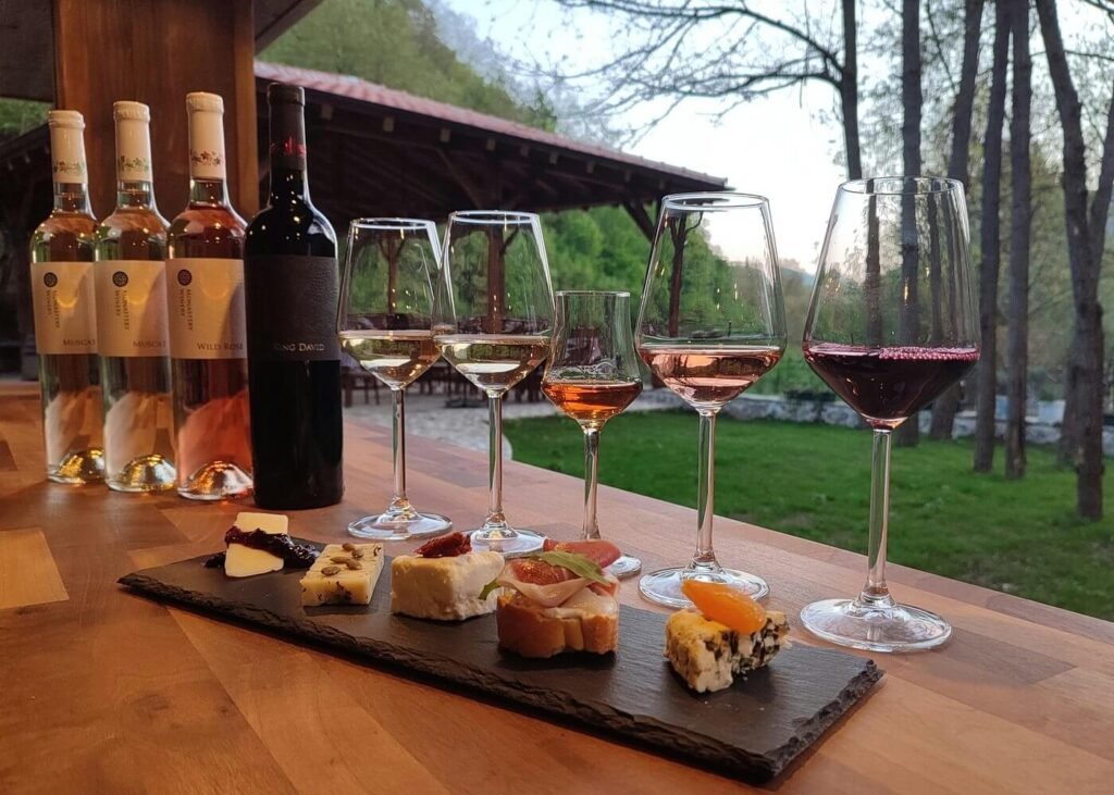 Guests enjoying wine tasting in Ohrid with local wines and food pairings at Monastery Winery